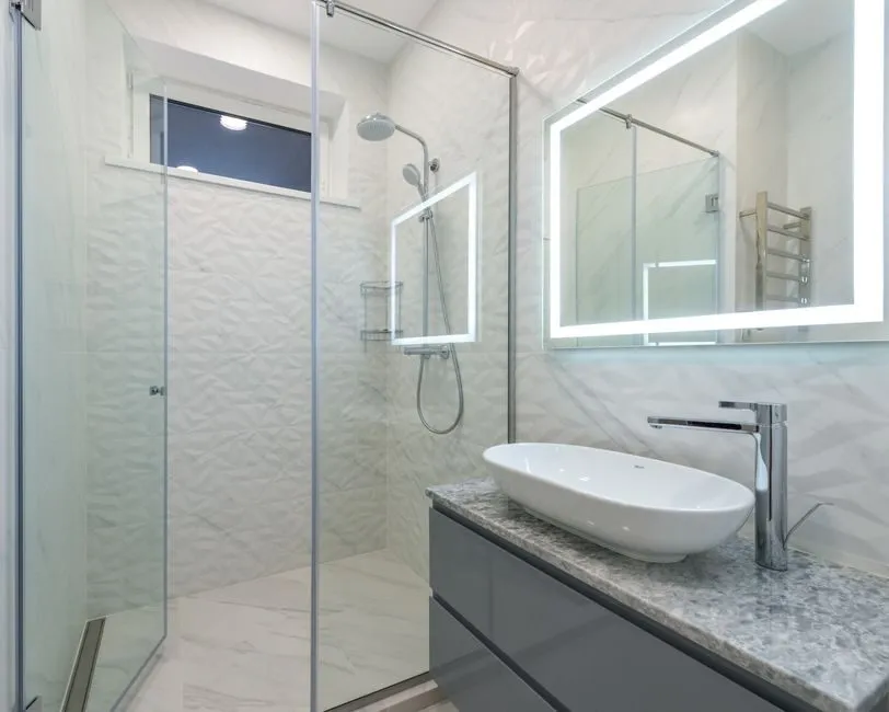 modern minimalist bathroom with walk-in shower and ambient lighting