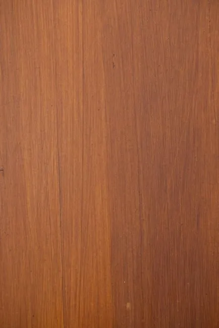 close-up of teak wood grain showing rich golden brown color and natural oil sheen