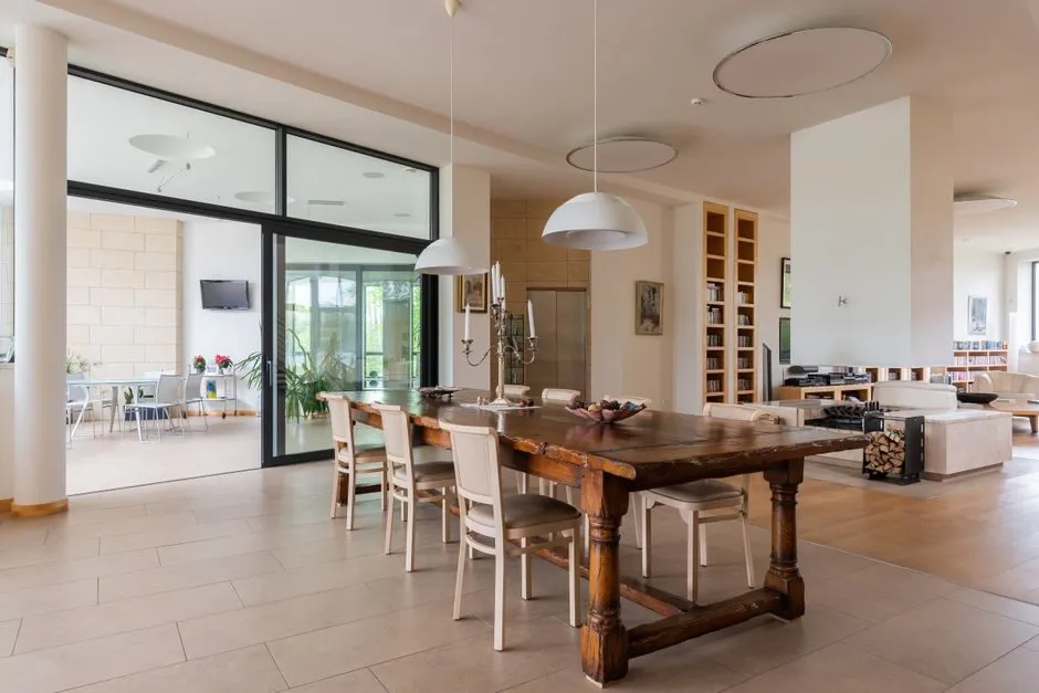 spacious neoclassical dining room with high ceiling and chandelier