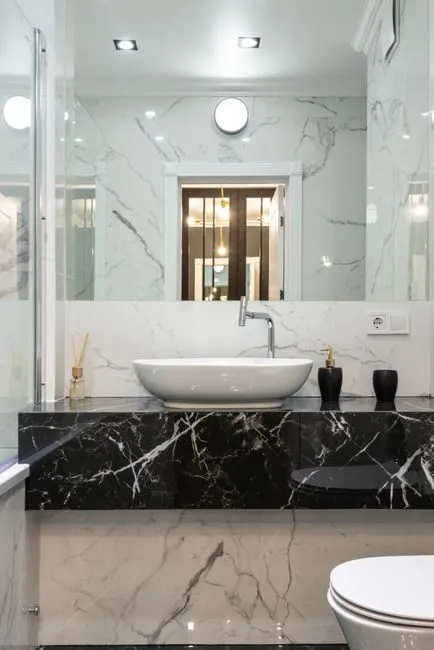 close-up of marble bathroom wall with brass fixtures