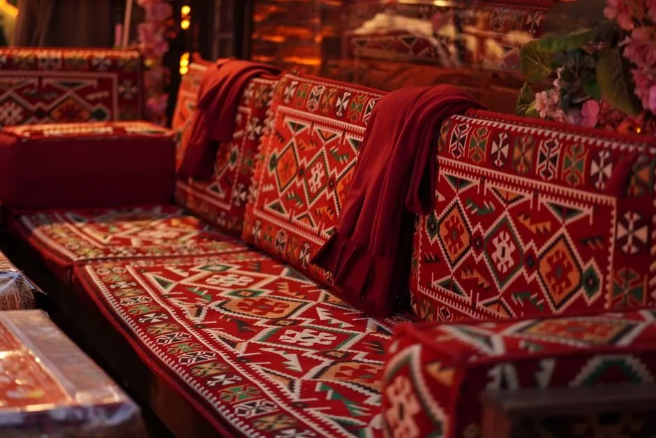 vibrant living room with red and orange accents combined with natural wood furniture