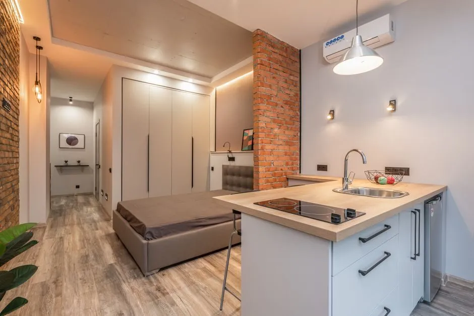 compact single-wall kitchen with white cabinets and modern appliances